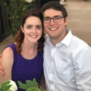 A man and woman posing for a photo at their wedding.