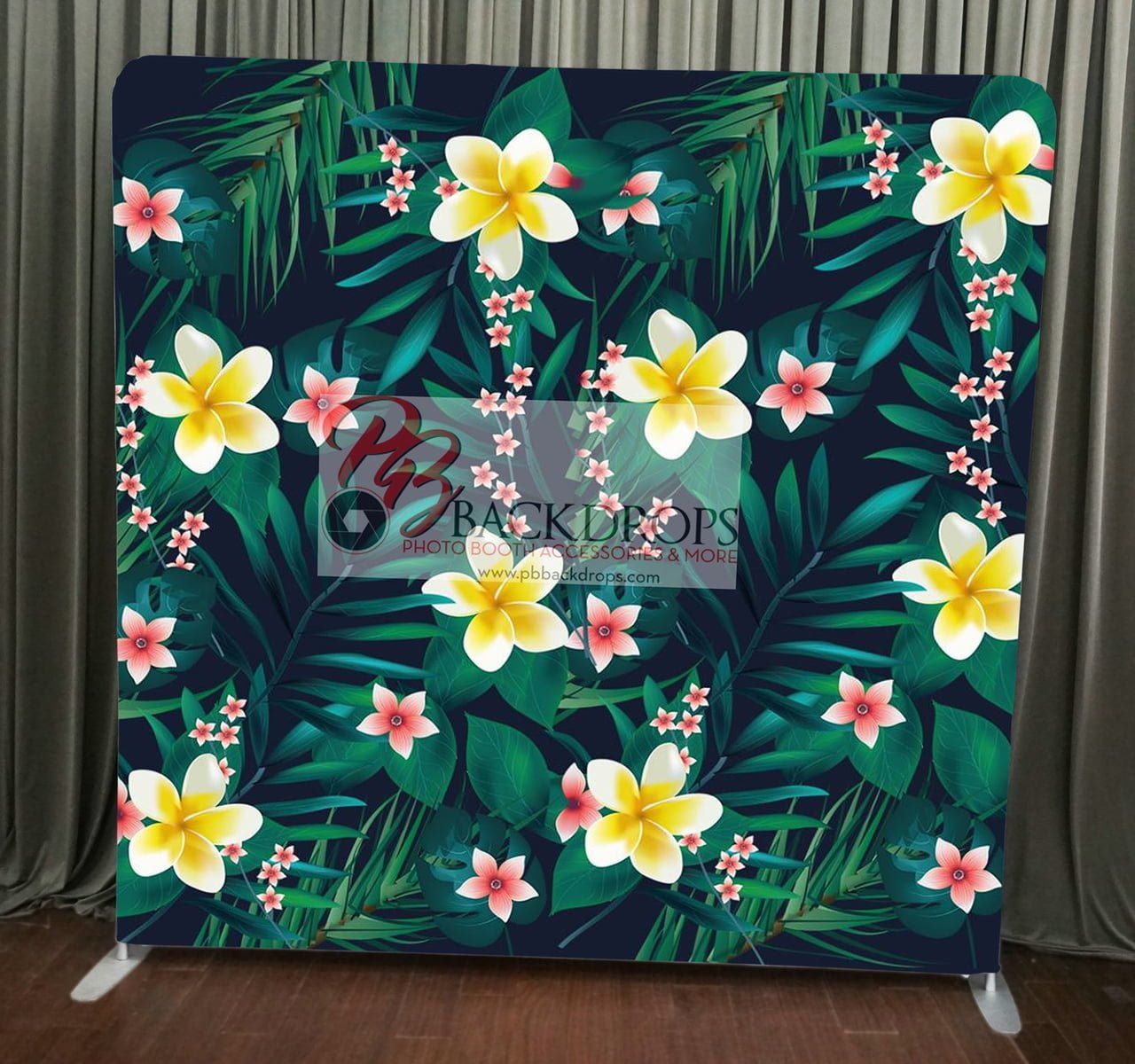 A photo backdrop with tropical flowers on it.