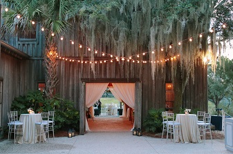 A wedding reception at a barn with string lights.
