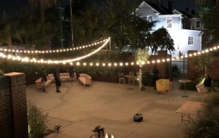 A patio with string lights at night.