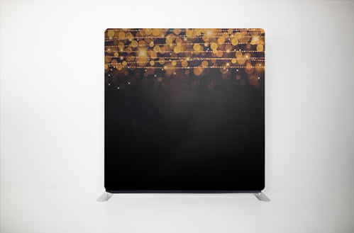A black and gold backdrop with lights on it.