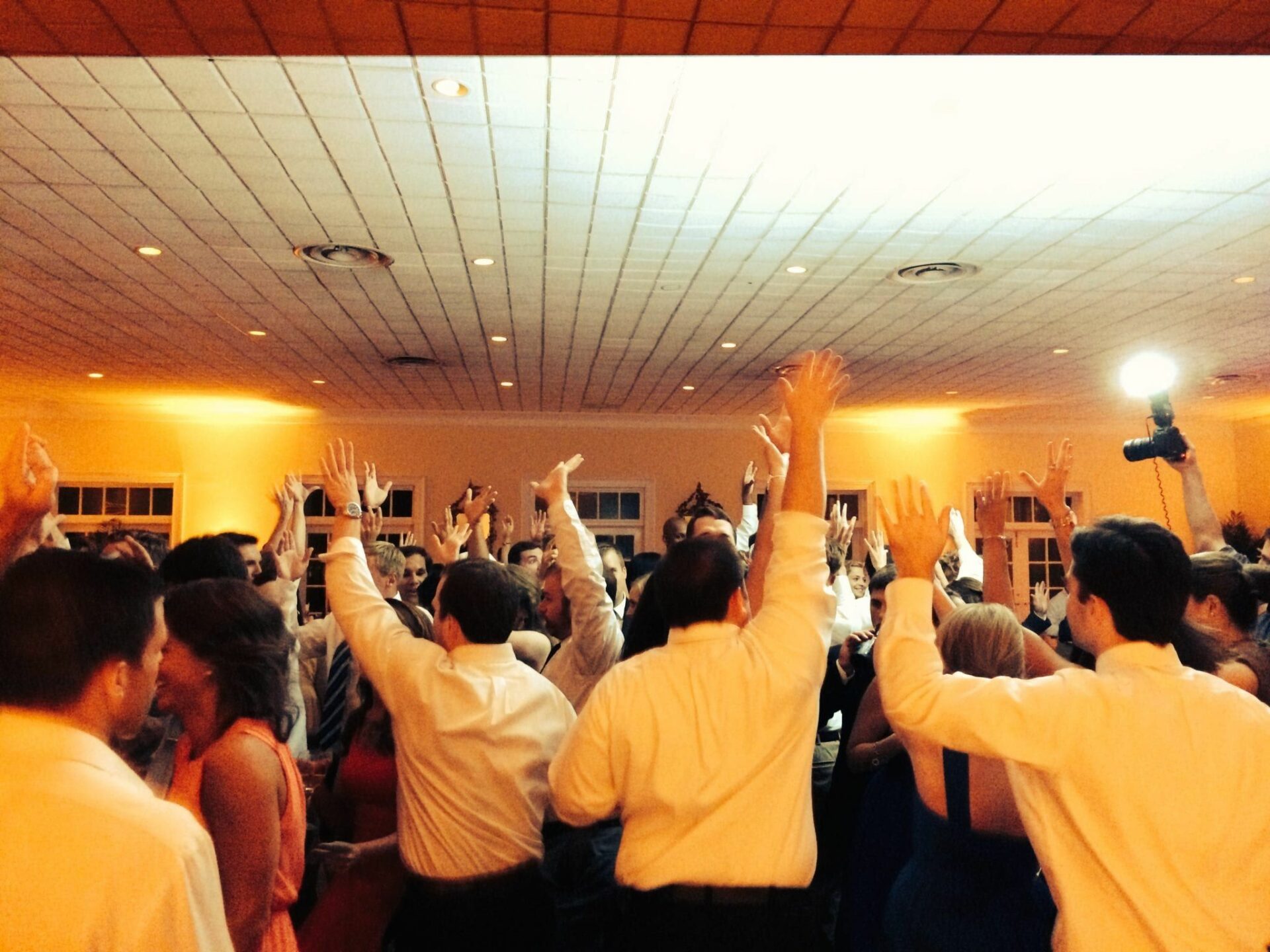 A group of people dancing on a dance floor at a Charleston wedding.