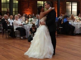 A bride and groom sharing their first dance at a wedding reception.