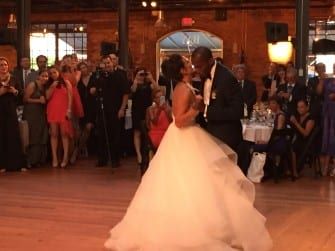 A bride and groom sharing their first dance at a wedding.