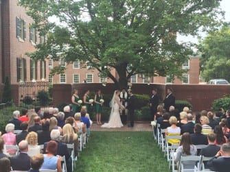 A romantic wedding ceremony under a stunning tree at the picturesque Carolina Inn.