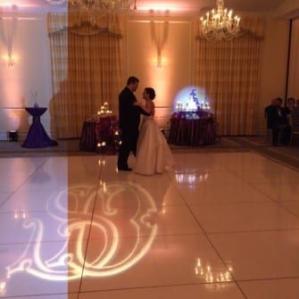 A bride and groom dancing on a white dance floor at the Carolina Inn.