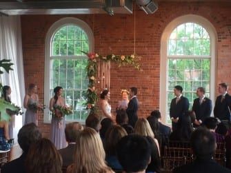 A wedding ceremony in an old brick building.