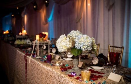 A table set up with candles and flowers.