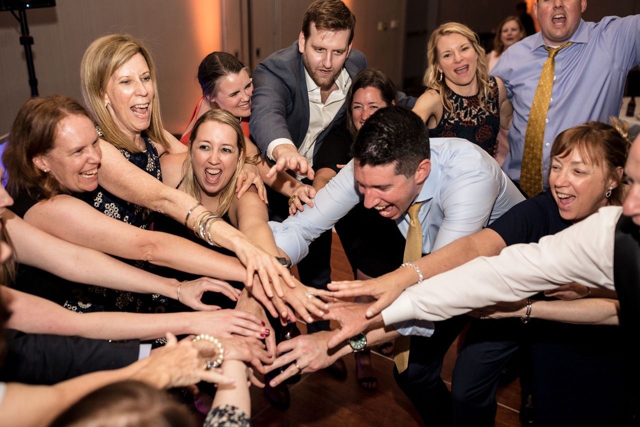A group of people making a hula hoop at a wedding reception.