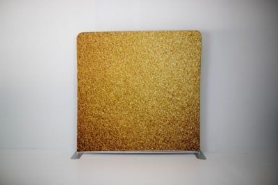 A gold glitter backdrop on a white background.