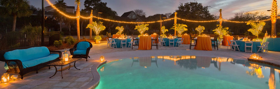 A poolside setting with blue and orange tables and chairs.