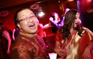 A bride and groom dancing on the dance floor at an indian wedding.
