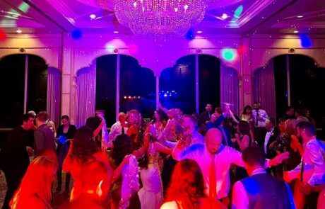 A group of people dancing at a wedding reception.