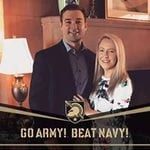 A couple standing in front of a fireplace with the words go army beat navy.