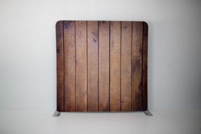 A wooden plank on a stand against a white wall.